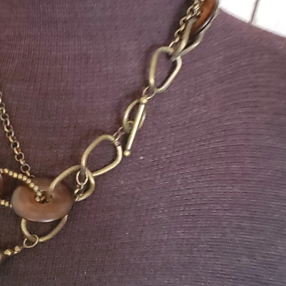 Bronze tone three strand necklace with tortoise shell look circles, brown